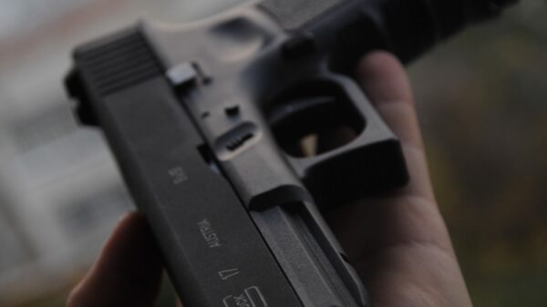 person holding black semi automatic pistol