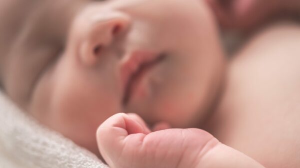 sleeping baby on white textile