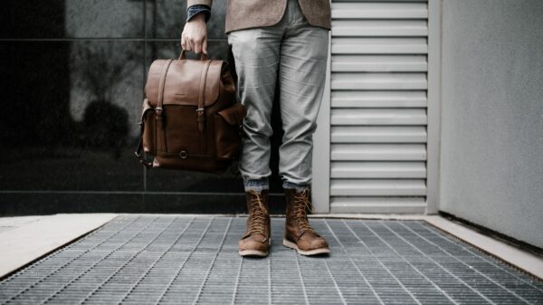 person holding brown leather bag