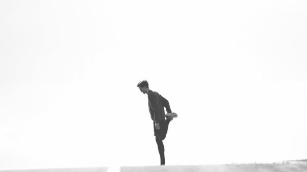 man wearing black jacket standing on street