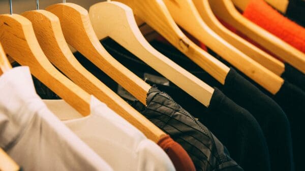clothes hanged on brown wooden hanger