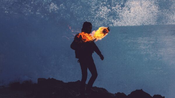 silhouette of man holding fire torch