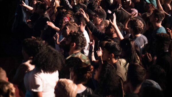 group of people putting hands up
