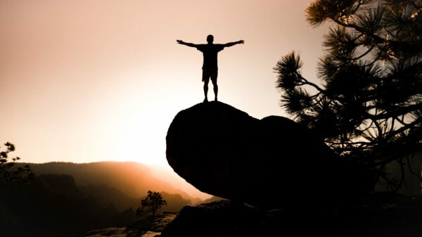silhouette of person on rock