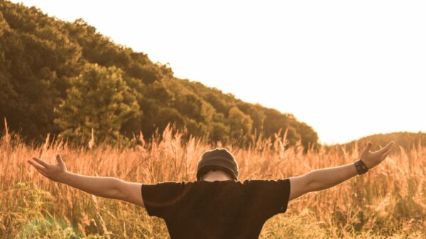 man standing in the middle of field