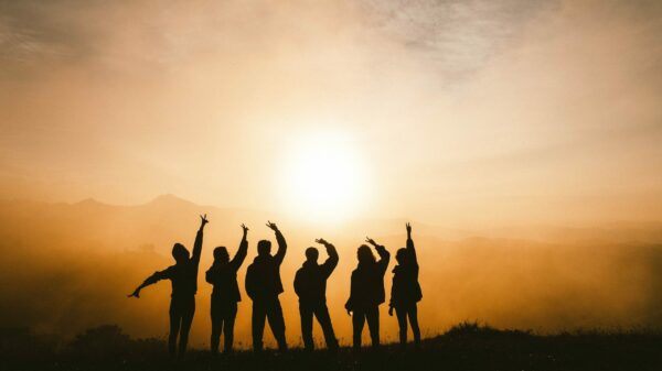 silhouette photo of six persons on top of mountain