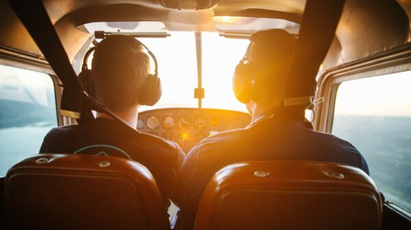 two men piloting plane during daytime