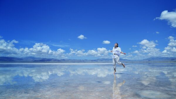 woman wearing white shirt walking on water during daytime