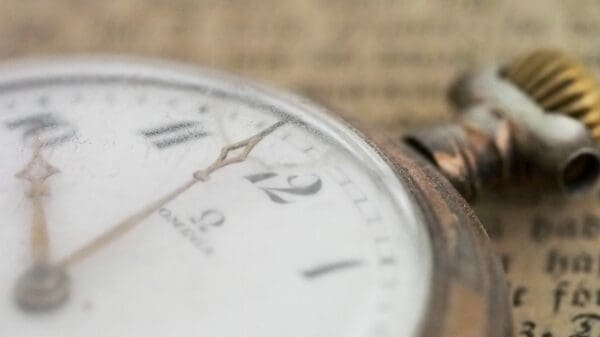 closeup photo of gold-colored pocket watch