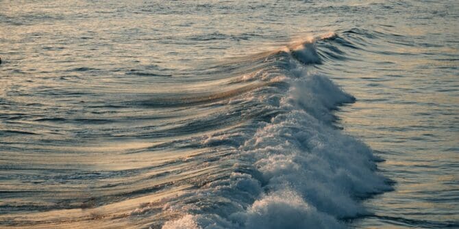 a man riding a wave on top of a surfboard